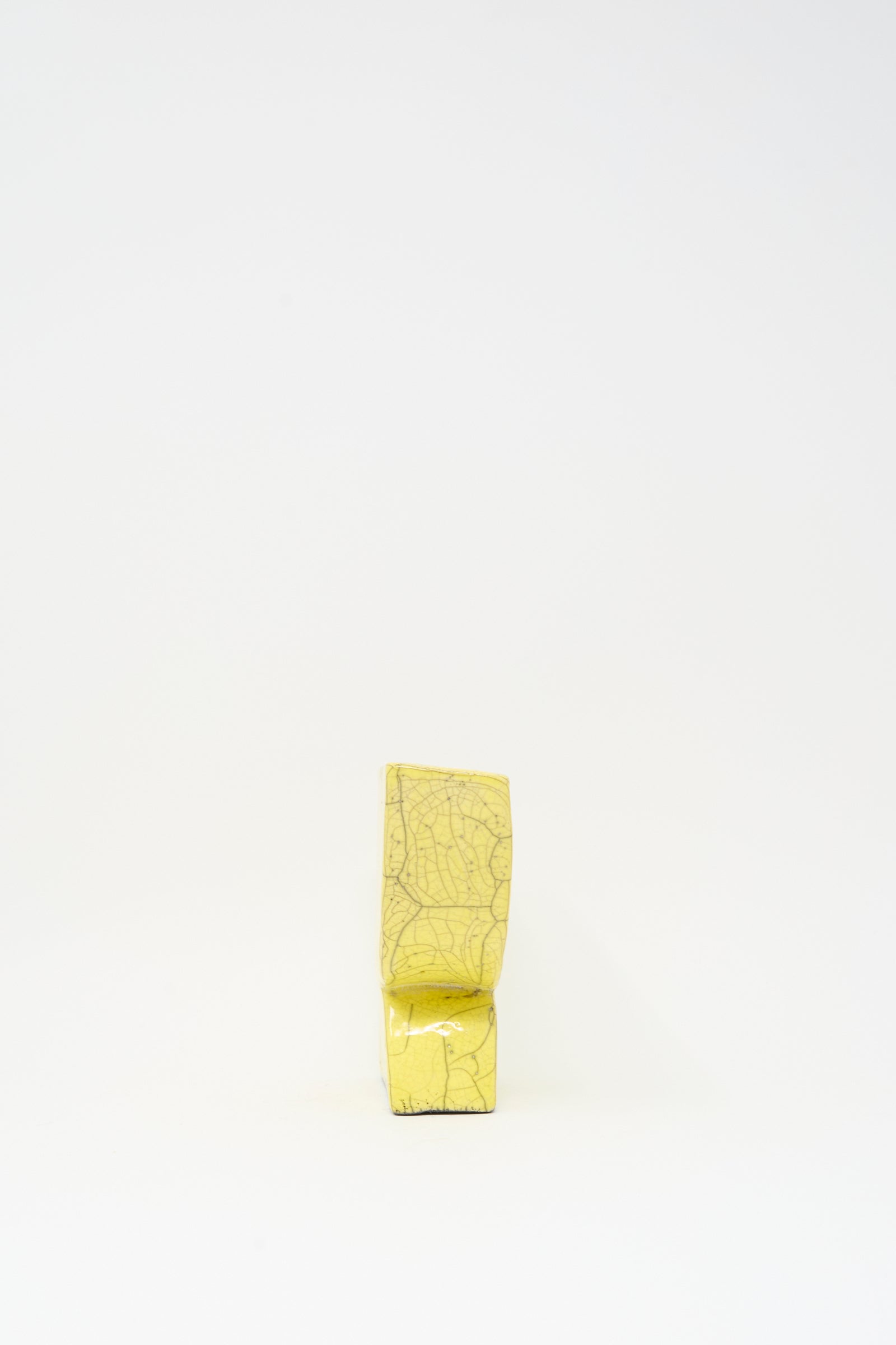 The MONDAYS Raku Semicircle Vessel in Yellow is a handmade, rectangular vase with visible crackle patterns, displayed upright against a plain white background.