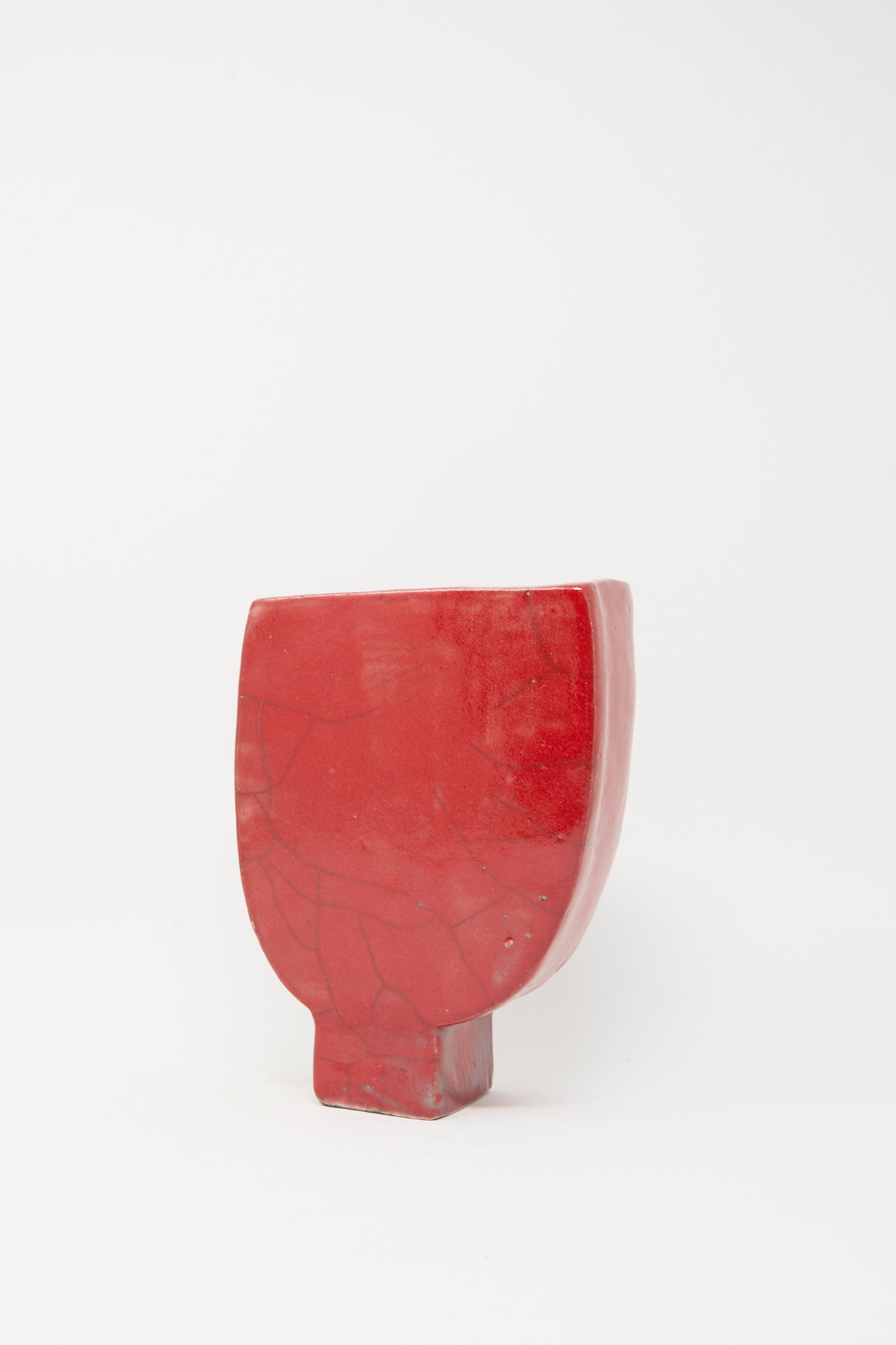 The MONDAYS Raku Vessel in Red is an irregularly shaped, handmade vase with visible cracks, photographed against a plain white background.