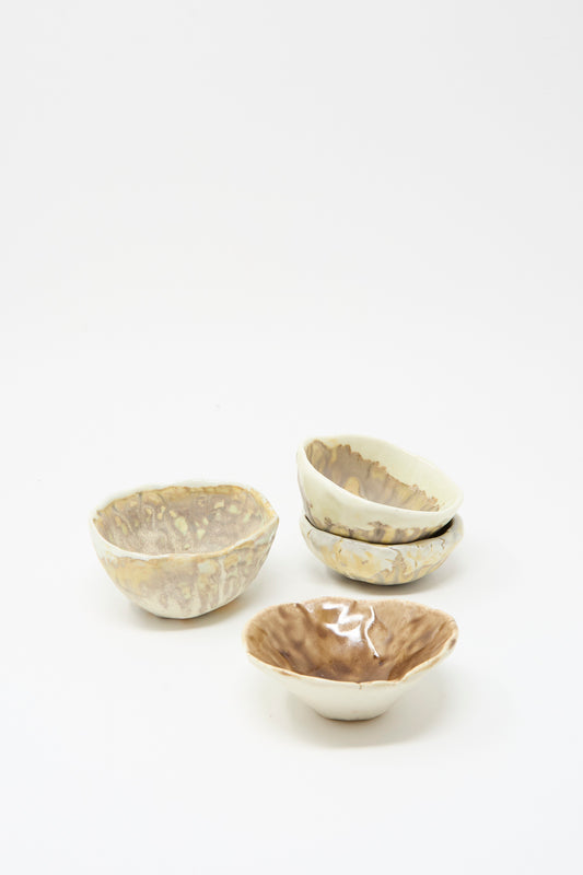 Four MONDAYS Small Pinched Bowls in Brown, each with unique beige and brown glazes and hand-pinched edges, are arranged on a plain white background.
