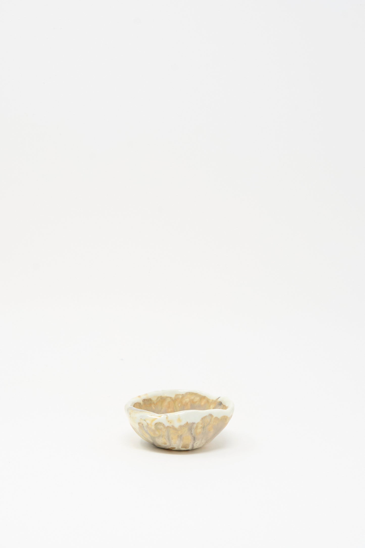 The MONDAYS Soda-Fired Pinched Bowl III is a small, round handmade bowl with a marbled beige and white design, crafted in Upstate NY pottery and photographed on a plain white background.