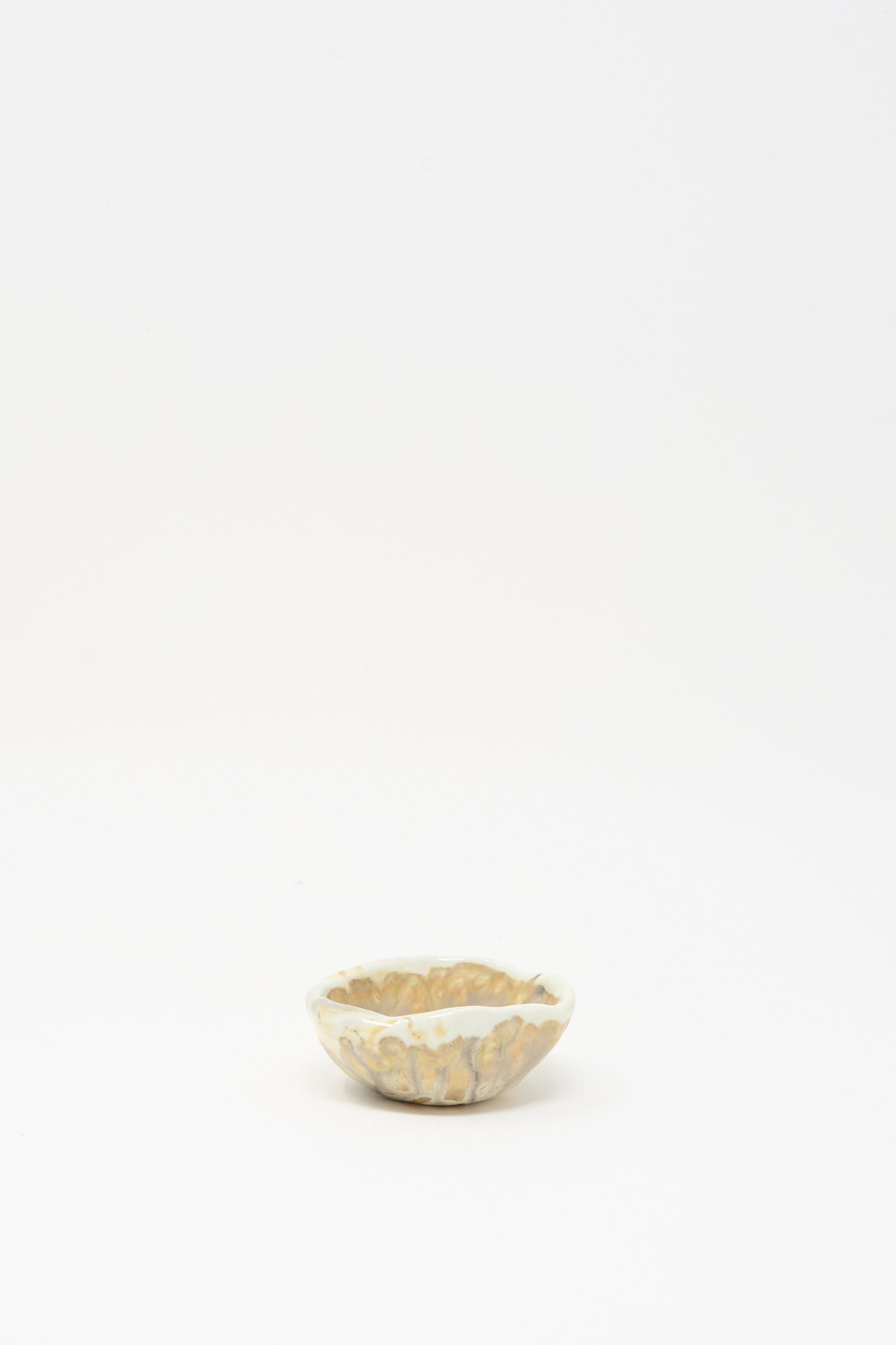 The MONDAYS Soda-Fired Pinched Bowl III is a small, round handmade bowl with a marbled beige and white design, crafted in Upstate NY pottery and photographed on a plain white background.