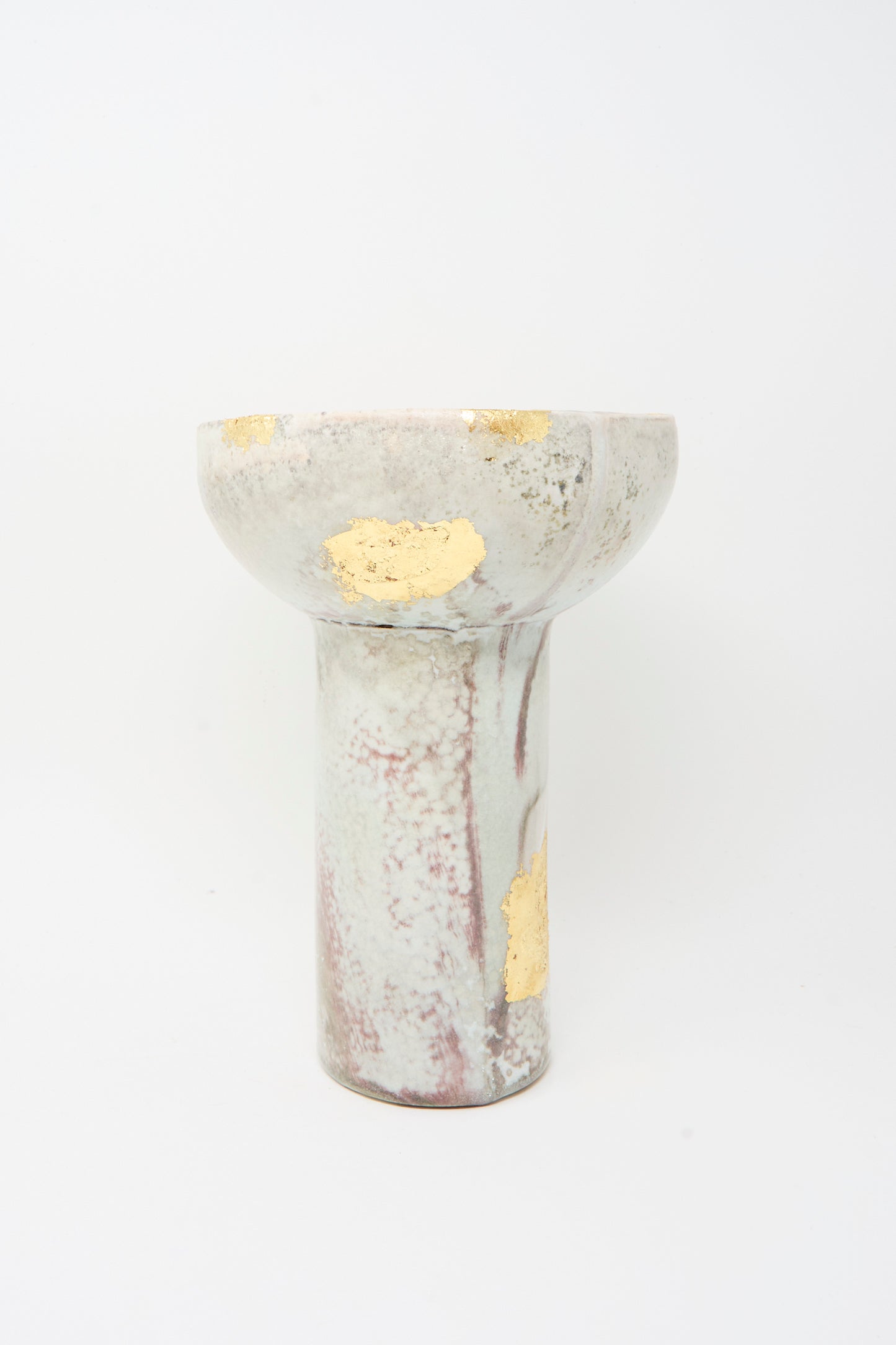The MONDAYS Wood-Fired Porcelain Pedestal Bowl features gold leaf accents and marbled patterns on a white base.