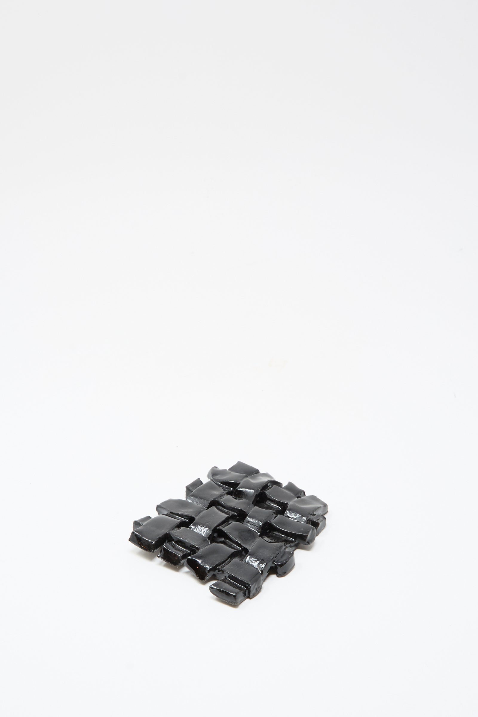 The MONDAYS Woven Dish in Black, a small rectangular ceramic piece with a glossy finish, is shown on a plain white background.