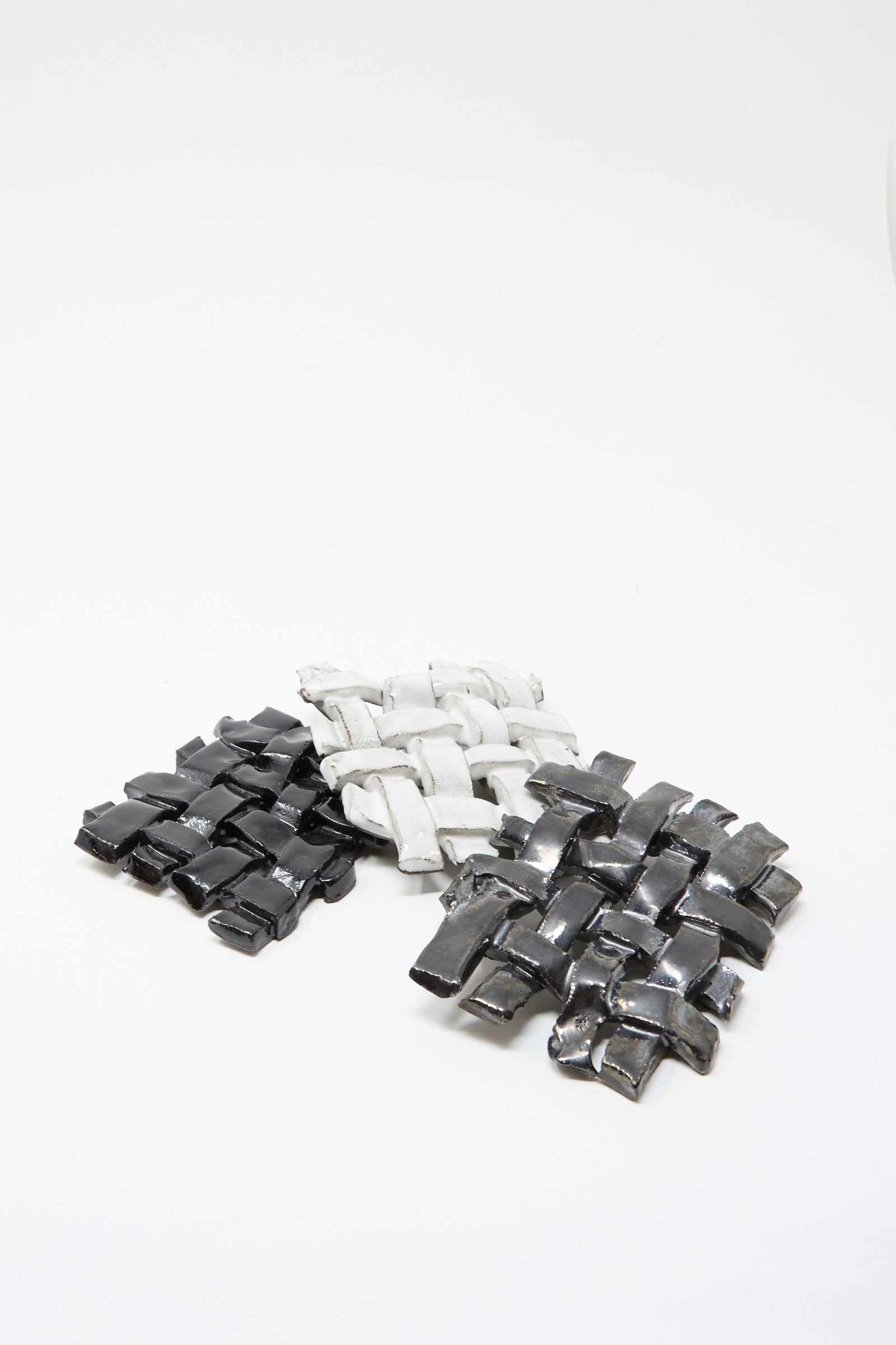 Three MONDAYS Woven Dishes in Black—featuring black glaze with gray and white tones—are arranged on a white background. Each artisanal piece is made in Brooklyn.