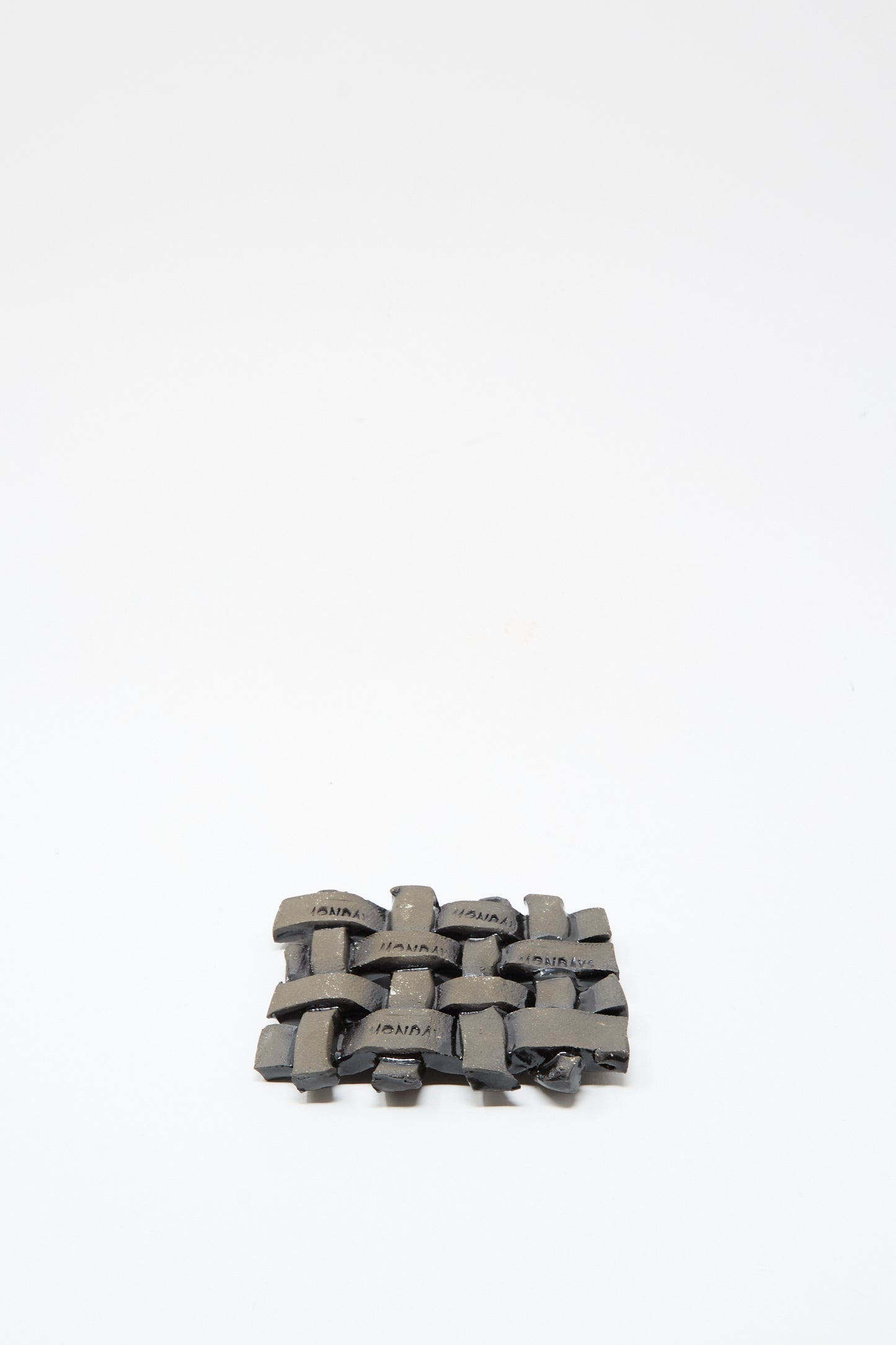 The MONDAYS Woven Dish in Black, a small rectangular ceramic piece with a sleek black glaze, is displayed centered on a plain white background.
