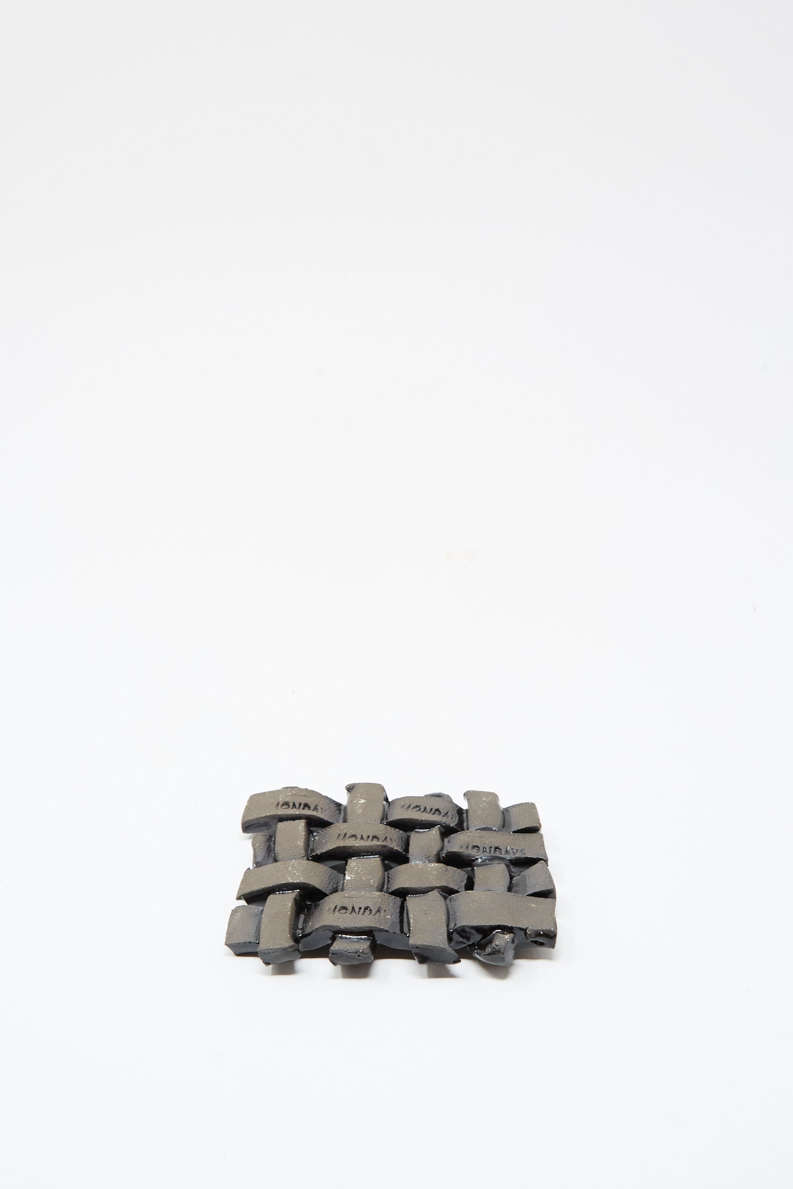 The MONDAYS Woven Dish in Black, a small rectangular ceramic piece with a sleek black glaze, is displayed centered on a plain white background.