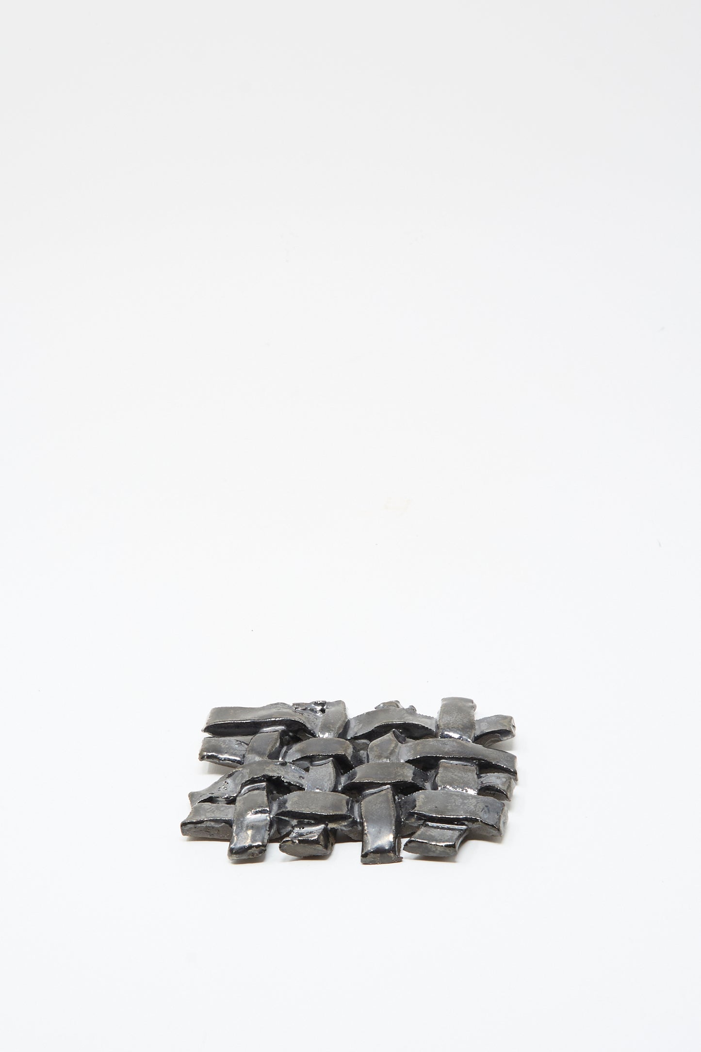The MONDAYS Woven Dish in Charcoal, a small rectangular ceramic piece with a charcoal glaze, is centered on a plain white background.