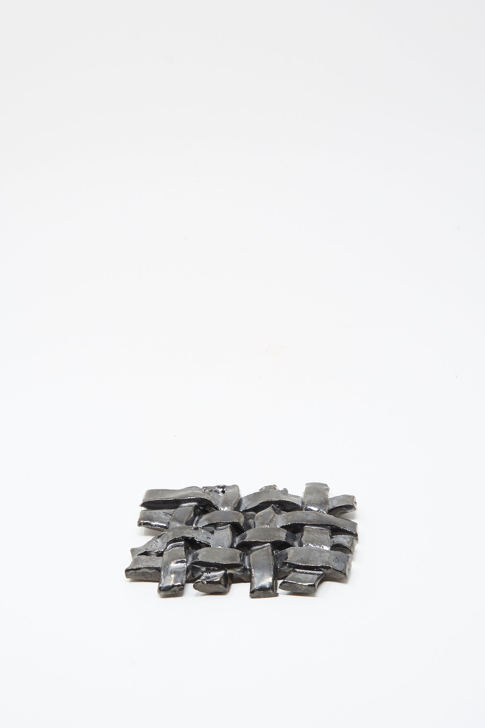 The MONDAYS Woven Dish in Charcoal, a small rectangular ceramic piece with a charcoal glaze, is centered on a plain white background.