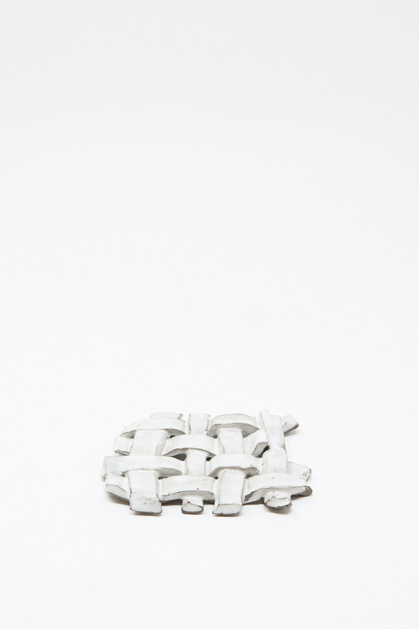 The MONDAYS Woven Dish in White, featuring a delicate white glaze and a woven ceramic design, is displayed on a plain white background.