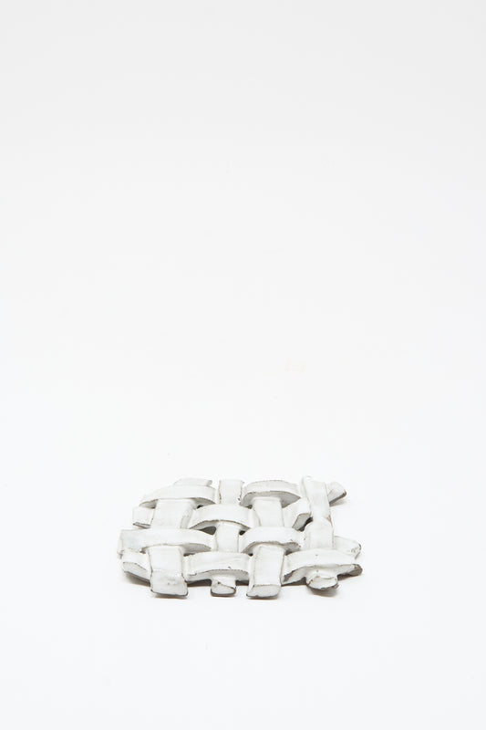 The MONDAYS Woven Dish in White, featuring a delicate white glaze and a woven ceramic design, is displayed on a plain white background.