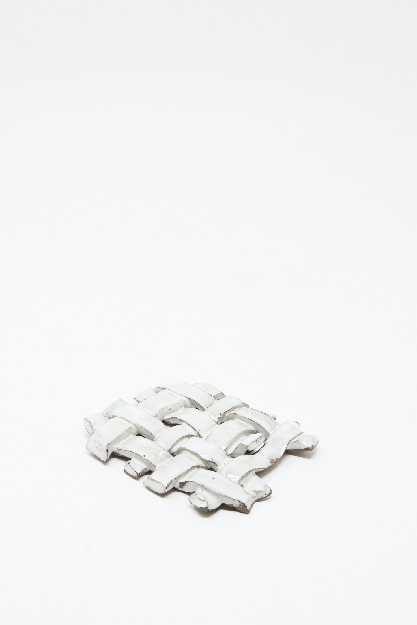 The MONDAYS Woven Dish in White, a small flat ceramic piece with a subtle white glaze, is displayed on a plain white background.
