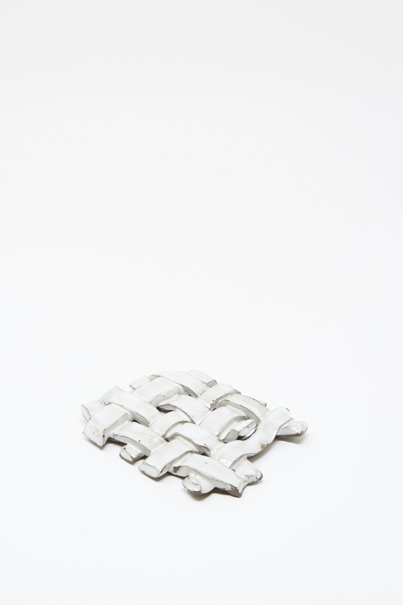 The MONDAYS Woven Dish in White, a small flat ceramic piece with a subtle white glaze, is displayed on a plain white background.