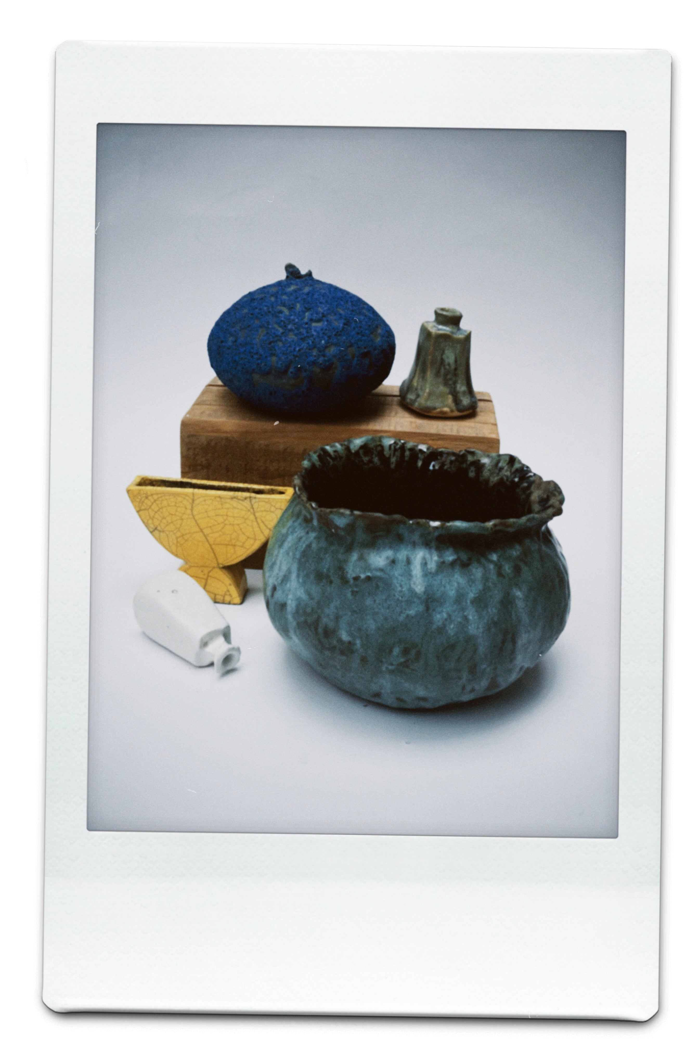 A polaroid of ceramics made by MONDAYS on a white background.