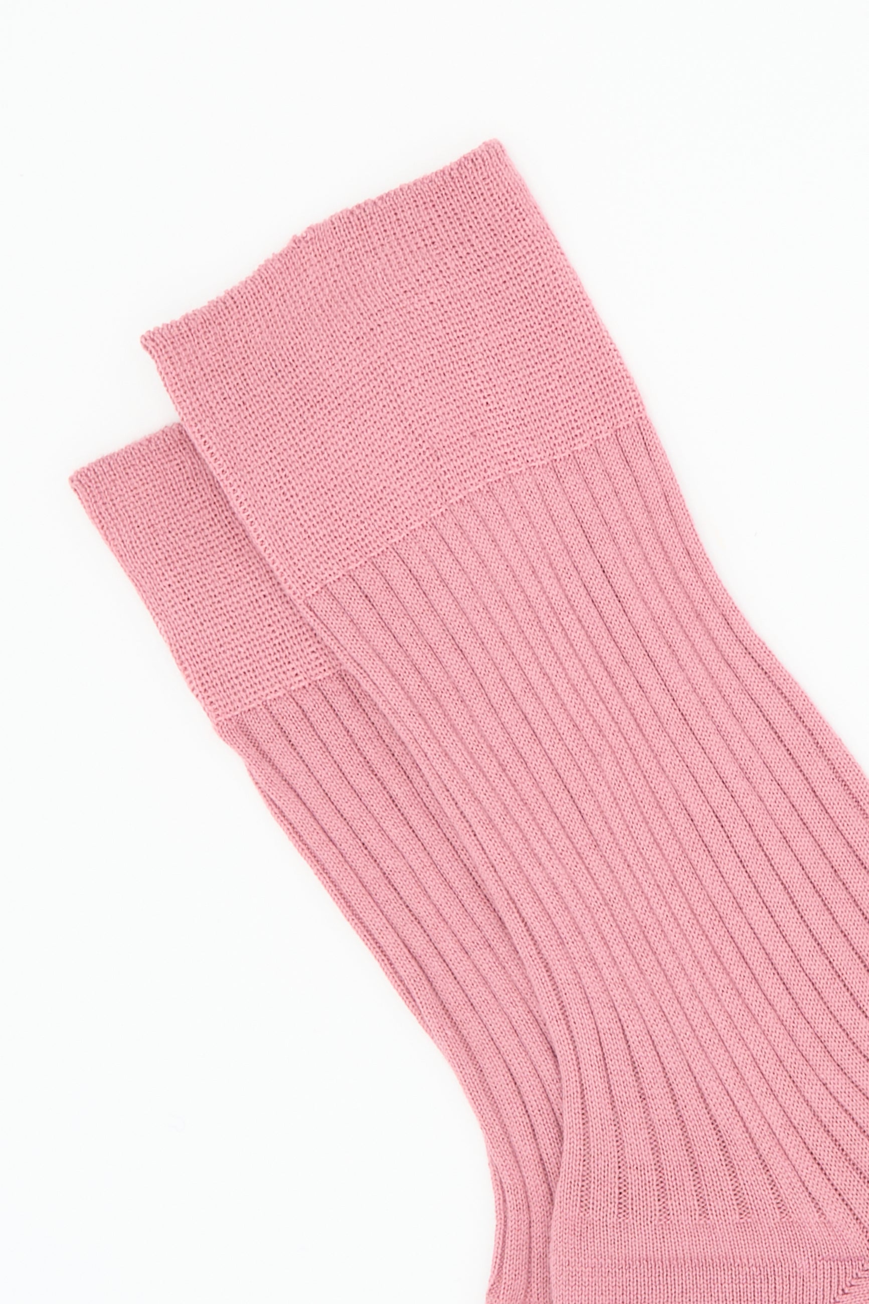 A close-up of two Bio Socks in Cameo by Maria La Rosa, made of ribbed cotton, laid flat and overlapping against a white background.