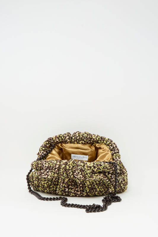 The Earth Game Crochet Bag in Natural by Maria La Rosa, with a chain strap and visible brand label, is elegantly displayed open to reveal its golden satin interior against a plain white background.