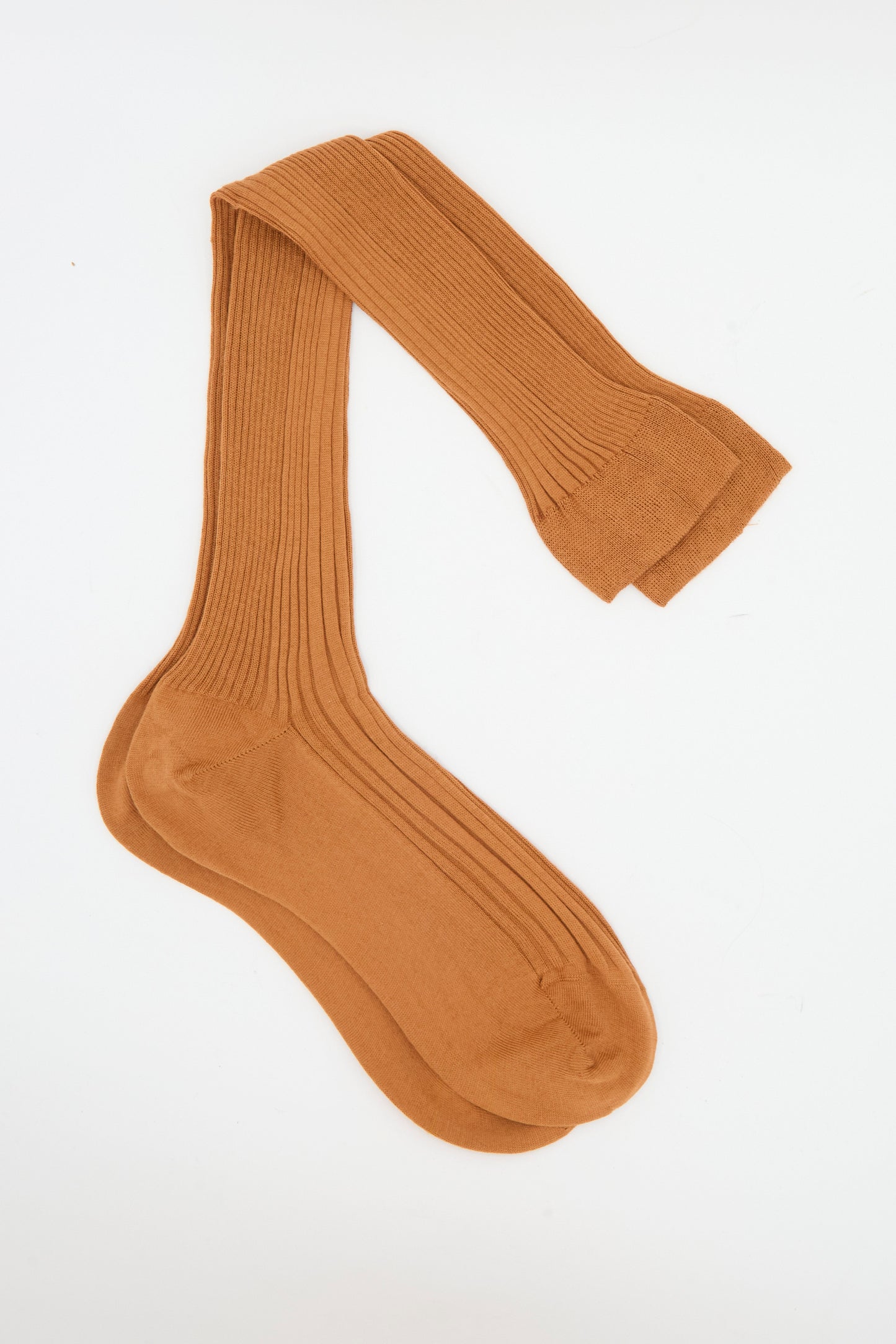 A pair of Maria La Rosa Long Sock in Cannella, light brown ribbed over-the-knee socks made in Italy, laid flat on a white background.