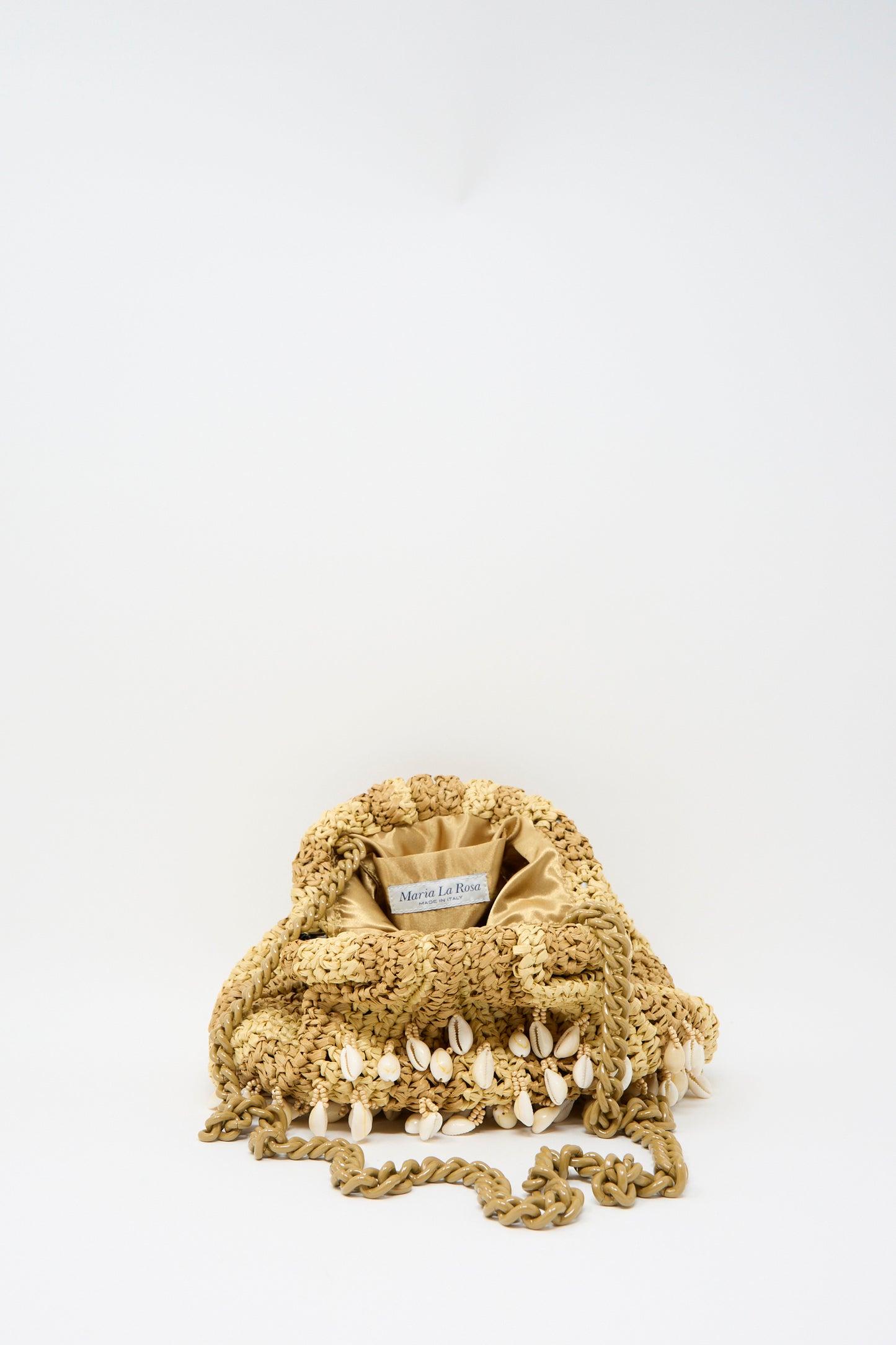 The Maria La Rosa Shell Mini Game Bag in Natural features a beige knit with a chain shoulder strap and shell embellishments, displayed on a plain white background.