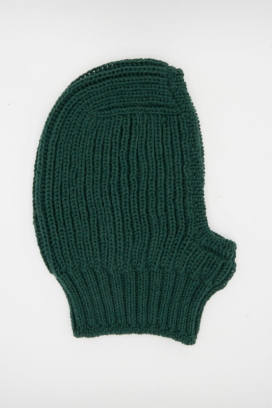 The Maria La Rosa Wool Balaclava Lina in Emerald, a dark green rib knit piece handmade in Italy, is laid flat on a white background.