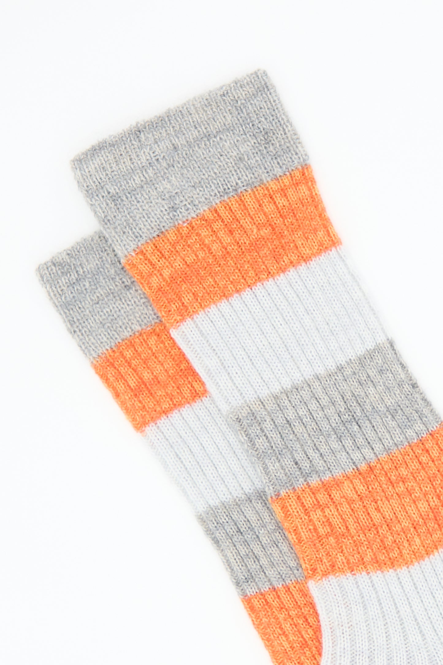 Two Maria La Rosa Sock in Rust mid-calf wool blend socks in gray with white and rust stripes.