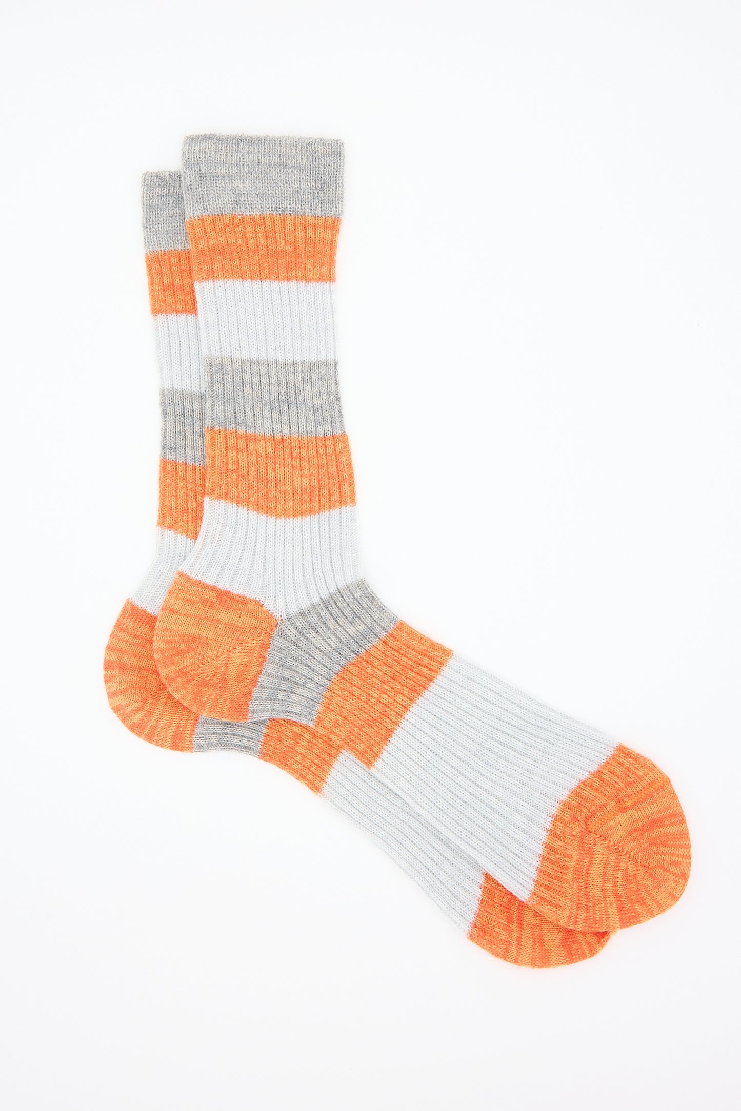 A pair of Sock in Rust from Maria La Rosa, featuring gray and rust stripes, made from a cozy wool blend, lay flat on a white background.