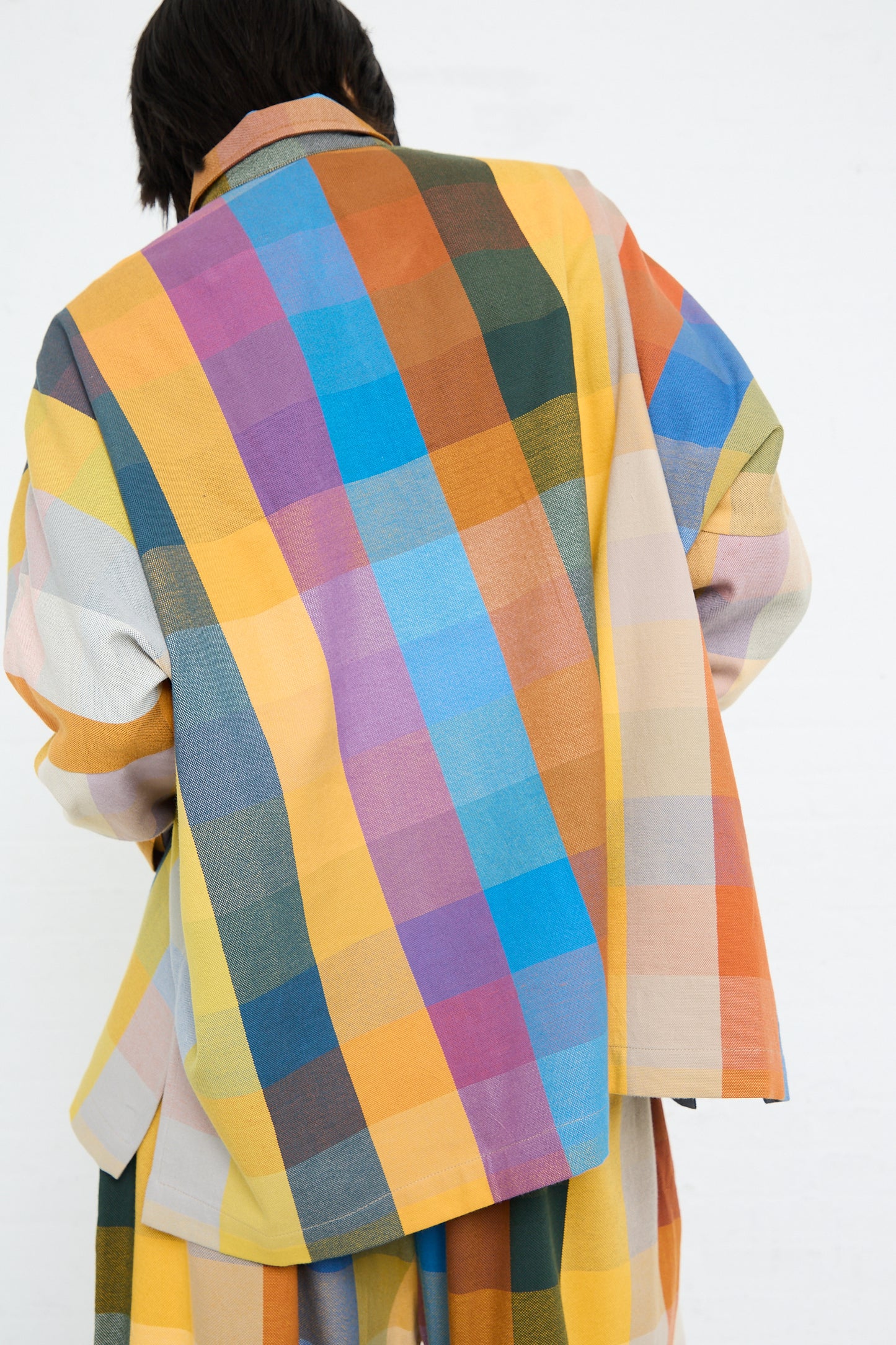 Person wearing a Marrakshi Life Cropped Tunic in Multi Check with a white background.