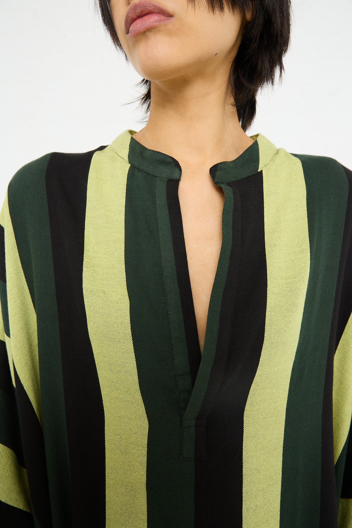 Close-up of a woman wearing an oversized Nero Collar Caftan in Green Stripe by Marrakshi Life.