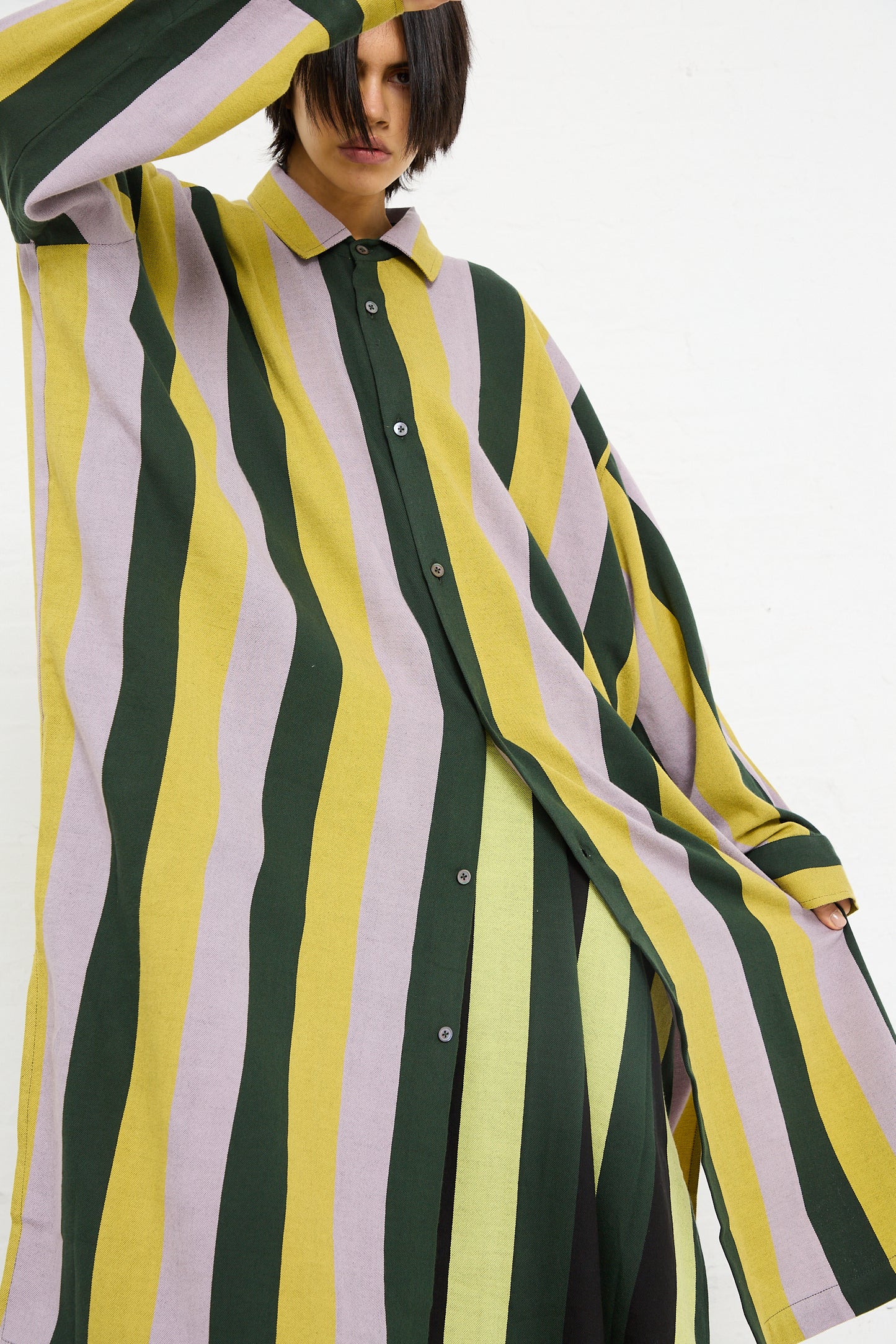 A person in a Small Collar Oversized Shirt in Stripe by Marrakshi Life with an extended sleeve draped over their head, made in Morocco.