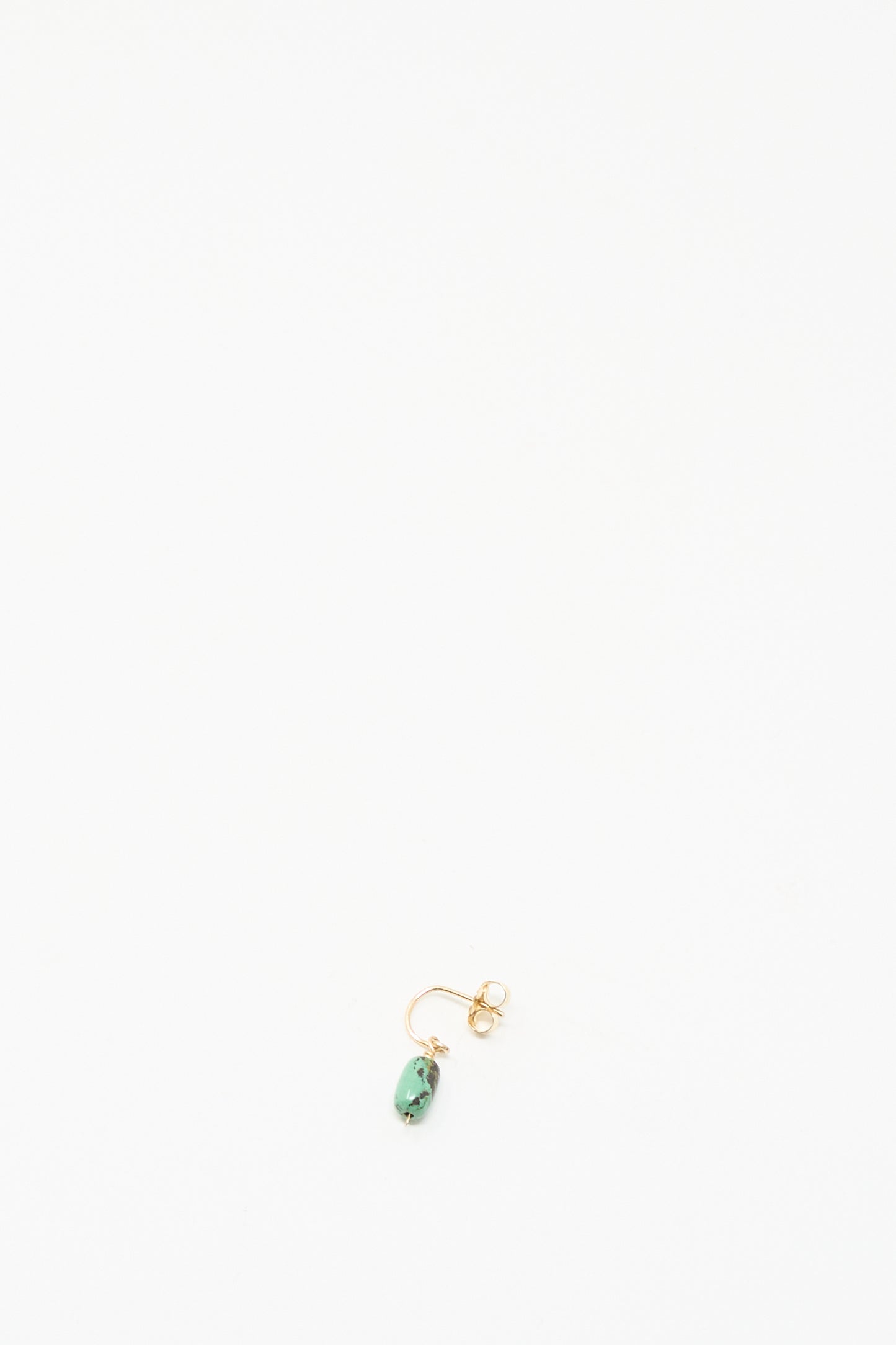 The Mary MacGill 14K Crescent Charm Earring in Turquoise, a single handmade gold stud with a small turquoise stone, is displayed on a plain white background.