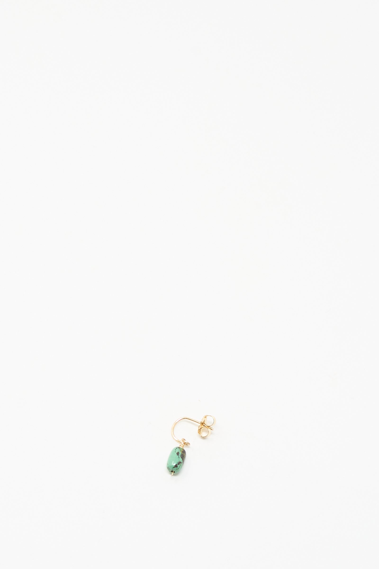 The Mary MacGill 14K Crescent Charm Earring in Turquoise, a single handmade gold stud with a small turquoise stone, is displayed on a plain white background.