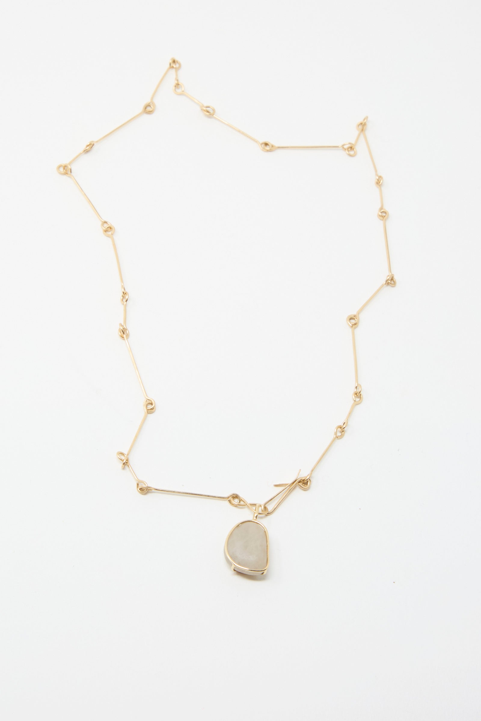 The Mary MacGill 14K Floating Bone Chain Necklace, showcasing a pendant in Block Island Stone on a gleaming gold chain against a pristine white background.