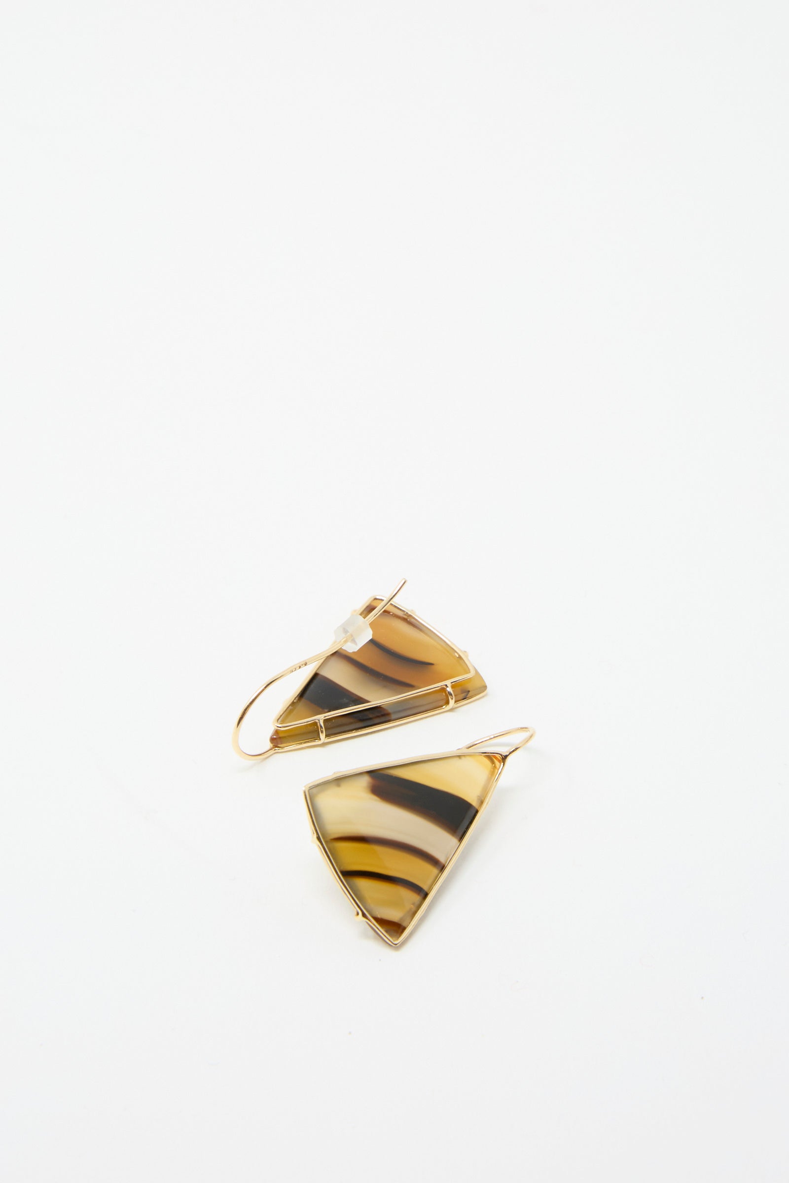 The 14K Floating Drop Earrings by Mary MacGill feature a triangular design with a banded agate tiger stripe pattern and 14k gold hooks against a white background.