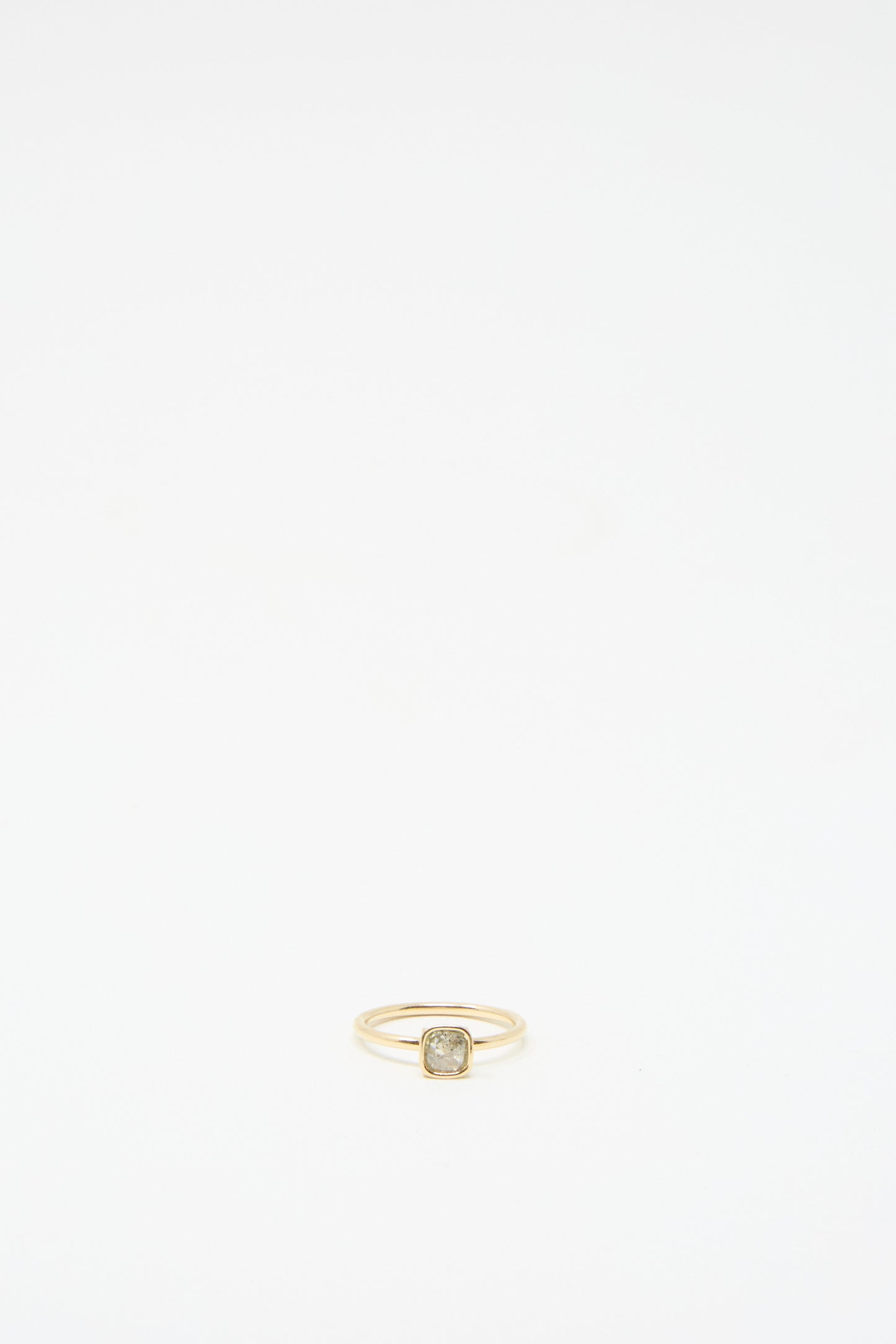 The 14K Floating Ring by Mary MacGill, featuring a square setting with a small salt and pepper rose cut mineral diamond, is displayed against a plain white background.