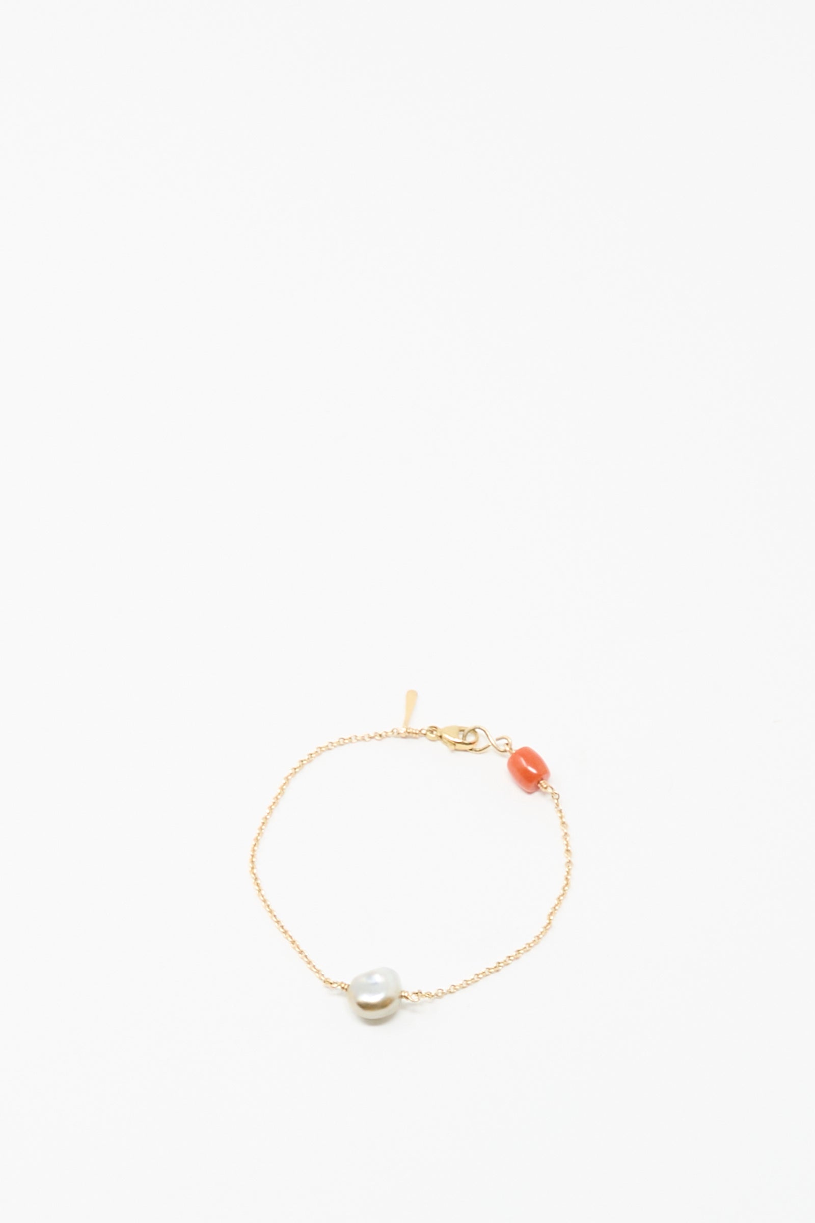The Mary MacGill 14K Stone Chain Bracelet in Coral and Keshi pearl features a single white Keshi pearl and orange coral bead on a delicate gold chain, shown against a plain white background.