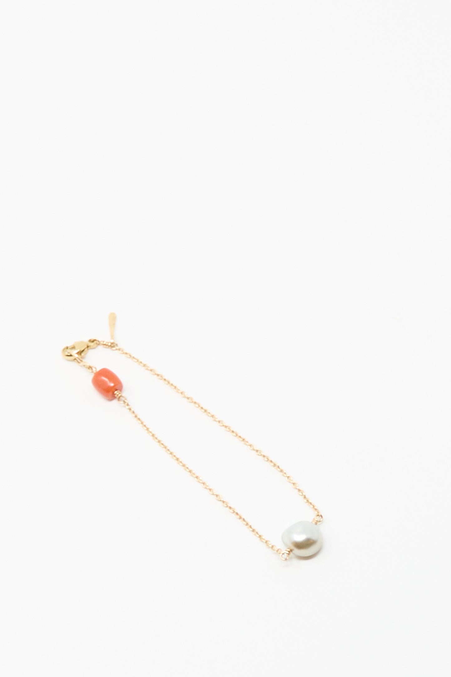 Mary MacGill's 14K Stone Chain Bracelet features a coral bead and a unique gray Keshi pearl, displayed on a white background.