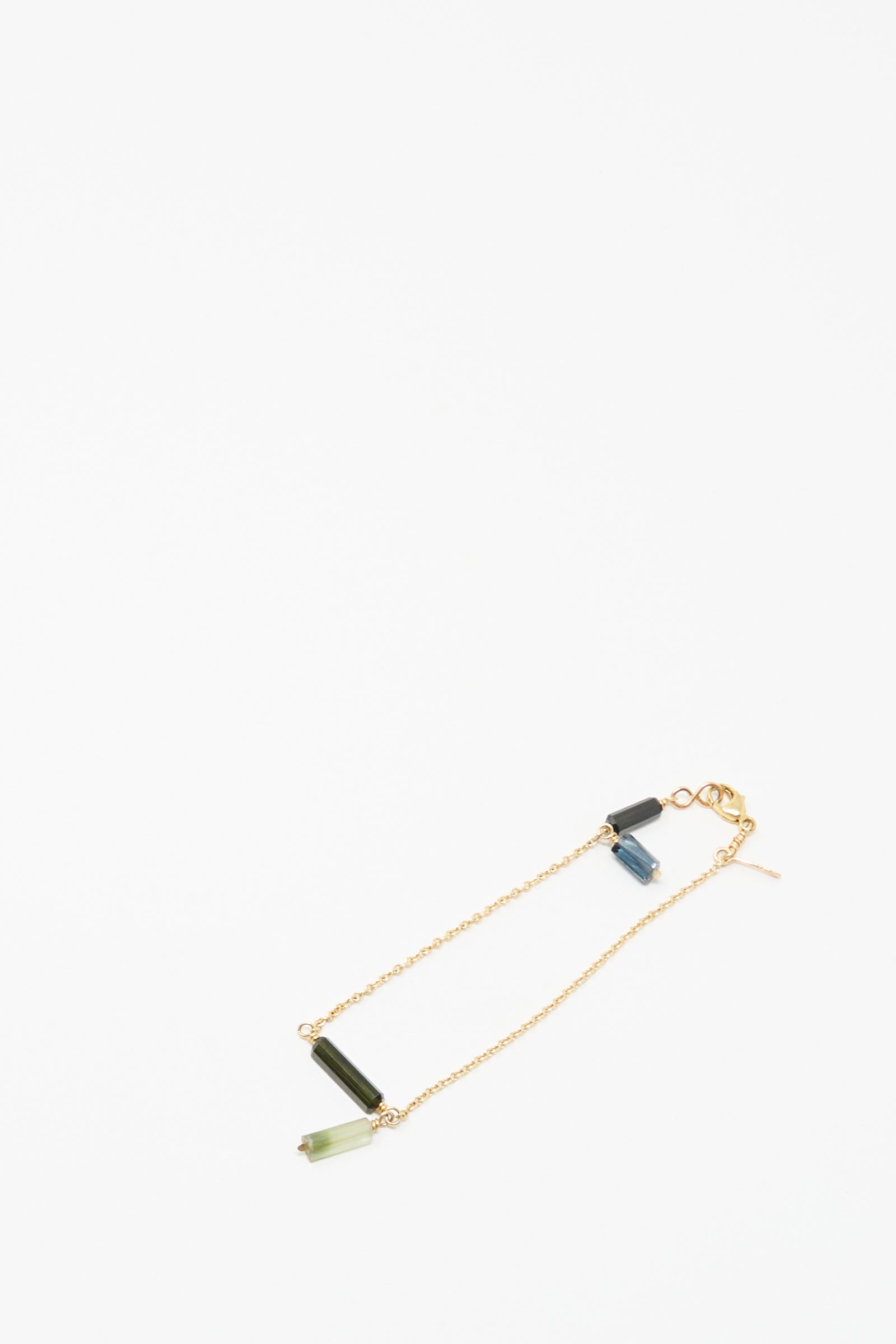 The Mary MacGill 14K Stone Chain Bracelet in Multi Tourmaline features three cylindrical gemstone charms in green, blue, and dark gray.