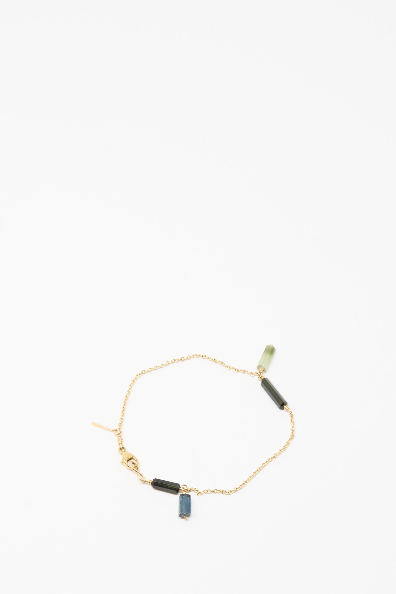 The Mary MacGill 14K Stone Chain Bracelet in Multi Tourmaline features three small rectangular green and blue tourmaline charms, showcasing modern handmade design on a white background.