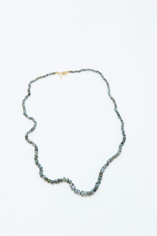 The Mary MacGill 14K Stone Layering Necklace in Cat's Eye 18" features small, round, greenish-blue beads and a 14k gold clasp, displayed on a plain white background.