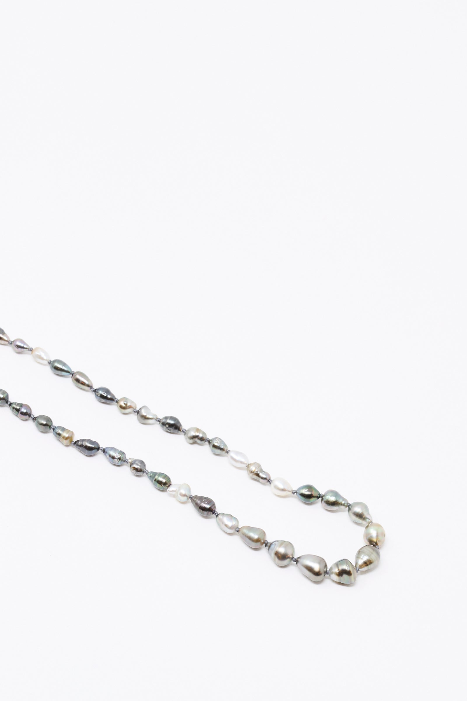 The Mary MacGill 14K Stone Layering Necklace in Keshi Pearl features a loop of irregular, multicolored pearls on a white background—ideal for layering or pairing with 14k gold accents.