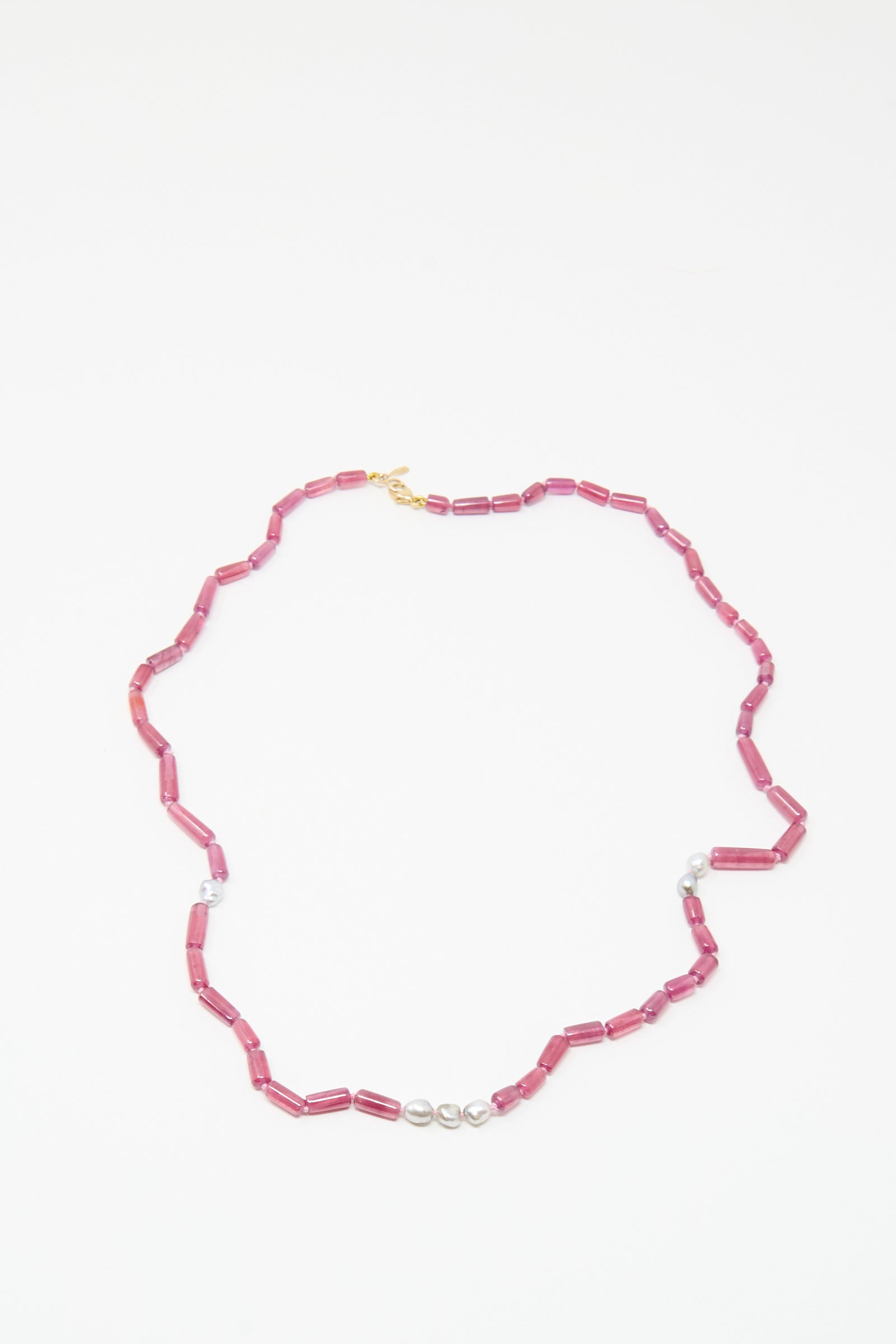 The Mary MacGill 14K Stone Layering Necklace features ruby cylindrical beads, Keshi pearls, and a gold clasp, displayed on a white background.