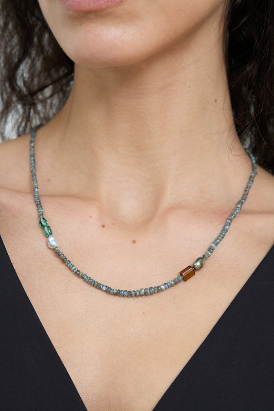 A woman wearing a Mary MacGill 14K Stone Layering Necklace in Green.
