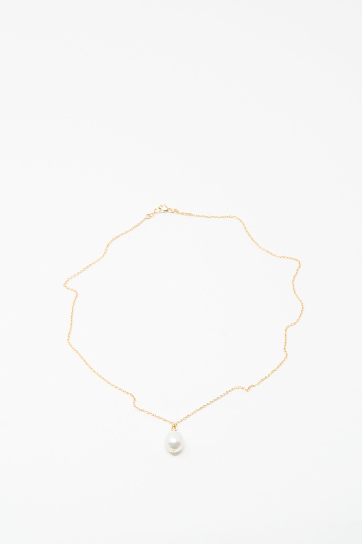 The Mary MacGill 14K Tahitian Pearl Drop Necklace in White is a delicate handmade gold chain with a single white pearl pendant, shown on a white background.