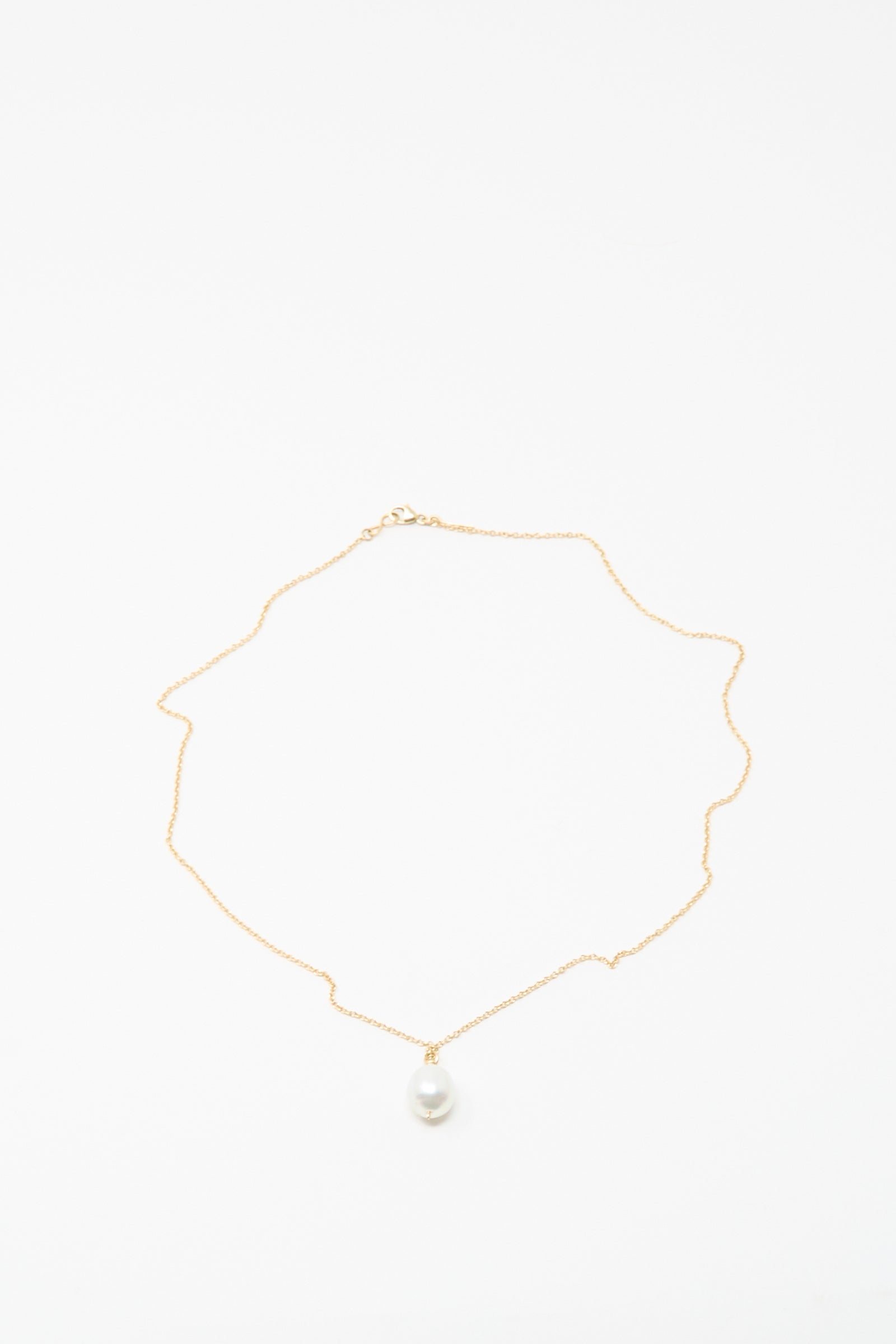 The Mary MacGill 14K Tahitian Pearl Drop Necklace in White is a delicate handmade gold chain with a single white pearl pendant, shown on a white background.