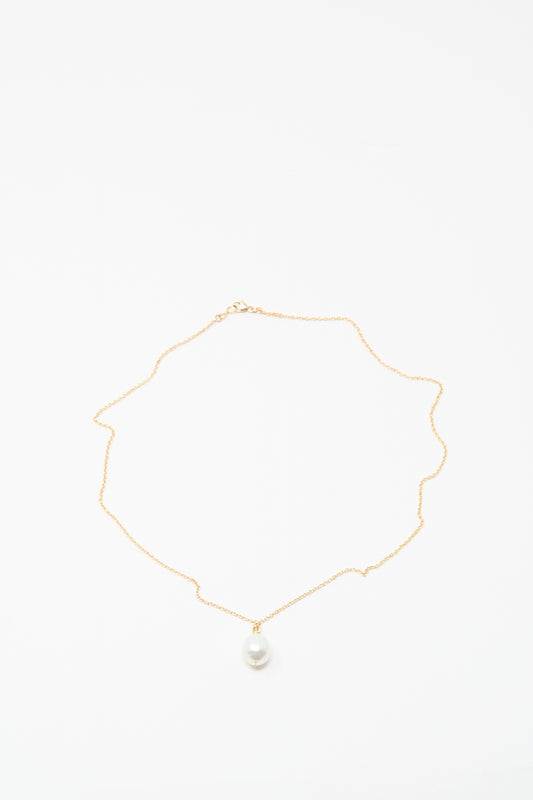 The Mary MacGill 14K Tahitian Pearl Drop Necklace in White is a delicate handmade gold chain with a single white pearl pendant, shown on a white background.