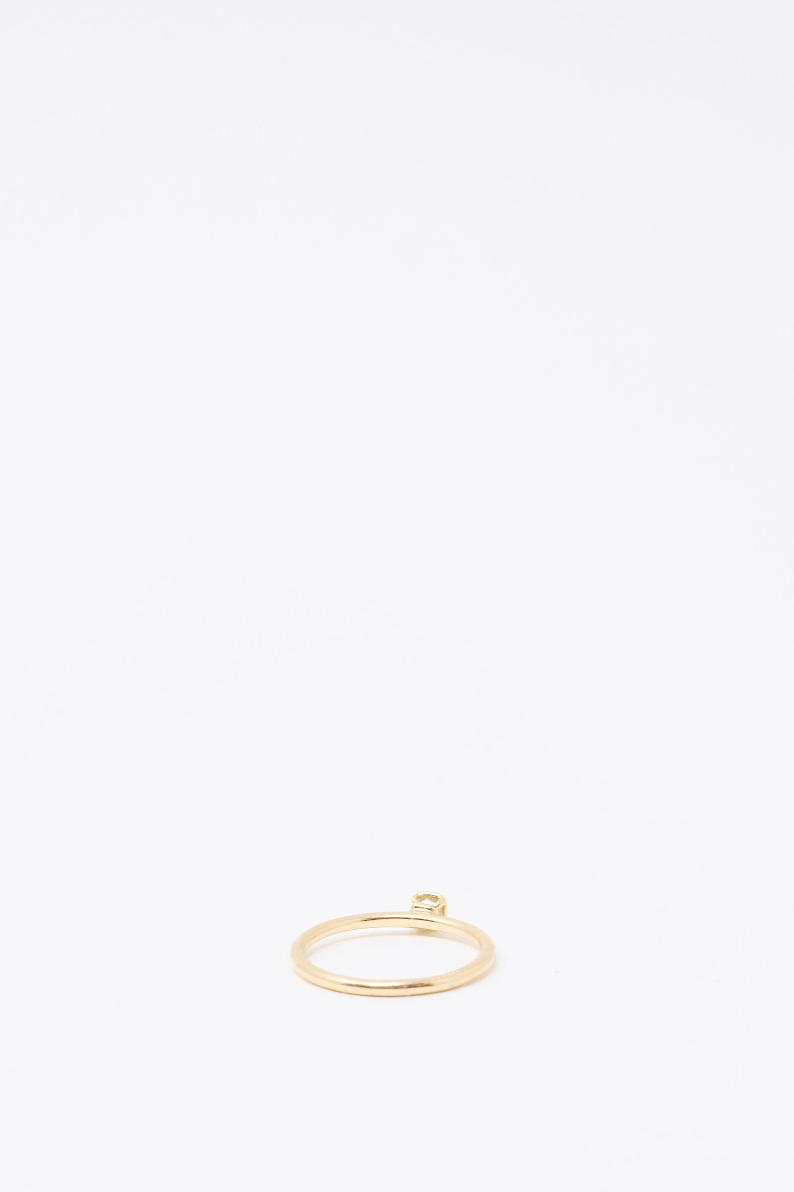 The Mary MacGill 14K Floating Ring features a petite, light green rose-cut mineral diamond, set atop a thin gold band and displayed against a plain white background.