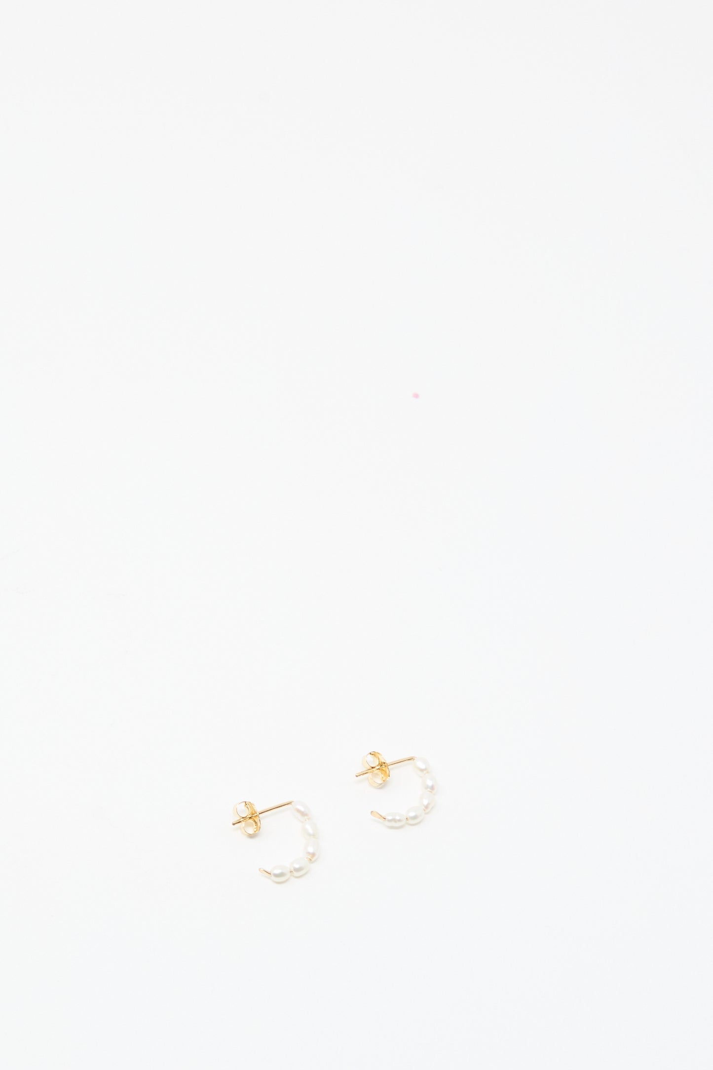 Mary MacGill Baroque Pearl Crescent Hoops: handcrafted small gold hoop earrings adorned with Baroque pearl accents, shown against a plain white background.