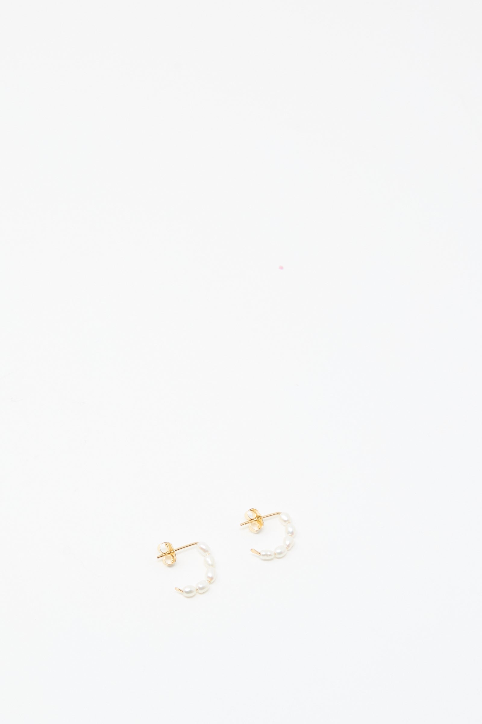 Mary MacGill Baroque Pearl Crescent Hoops: handcrafted small gold hoop earrings adorned with Baroque pearl accents, shown against a plain white background.