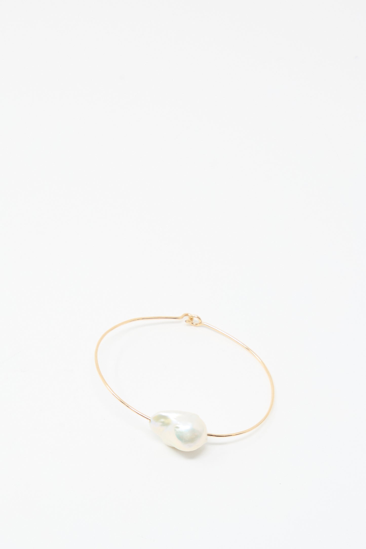 The Mary MacGill Baroque Pearl Cuff Bracelet in White features a large white baroque pearl on a delicate gold-filled cuff, shown against a plain white background.
