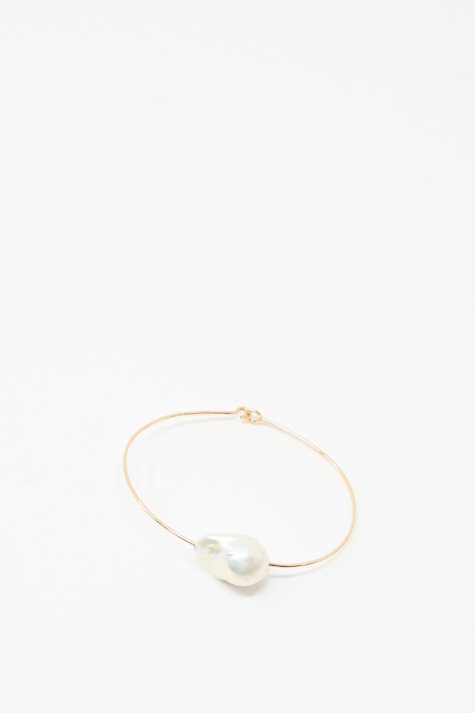The Mary MacGill Baroque Pearl Cuff Bracelet in White features a large white baroque pearl on a delicate gold-filled cuff, shown against a plain white background.