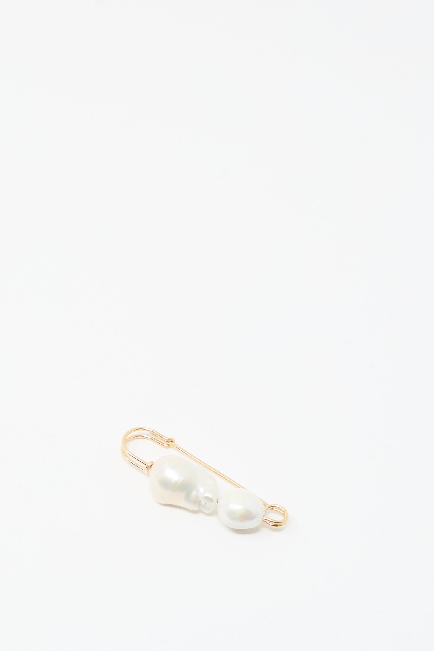 The Mary MacGill Baroque Pearl Pin in White features two handmade Baroque pearls on a gold-filled safety pin, shown against a plain white background.