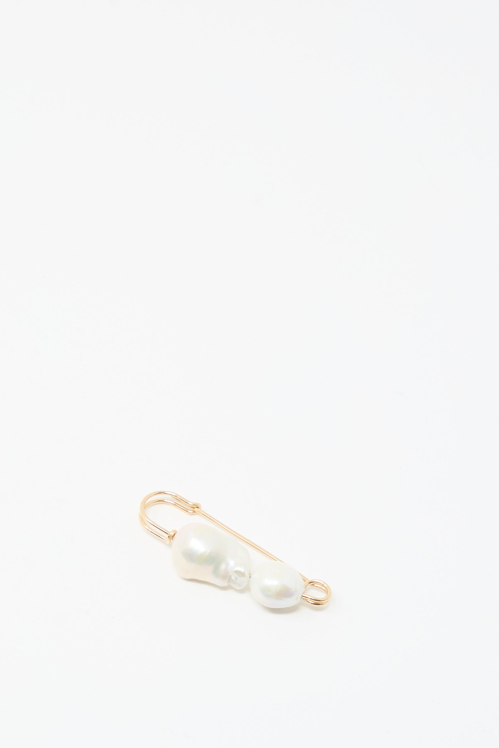 The Mary MacGill Baroque Pearl Pin in White features two handmade Baroque pearls on a gold-filled safety pin, shown against a plain white background.